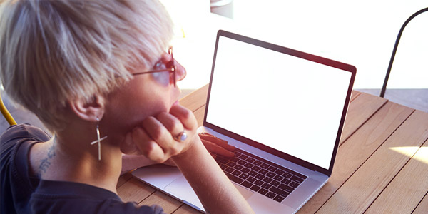 Photo of girl sitting at laptop